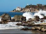 Bay in Puerto Escondido with hotel and lighthouse, Mexico