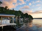 Lake house with pier and woods with sunrise in the morning in New York state Finger Lakes; 