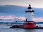 Dusk view of Tarrytown lighthouse with Tappan Zee bridge on the background; 